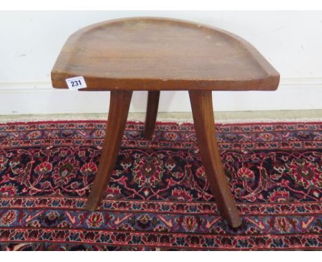 A mahogany three leg stool