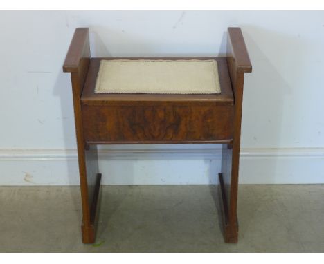 A walnut veneered lift lid piano stool 