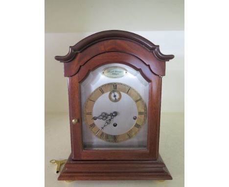 A modern German mahogany three train Westminster chiming mantel clock with a silvered dial and brass chapter ring signed Jose
