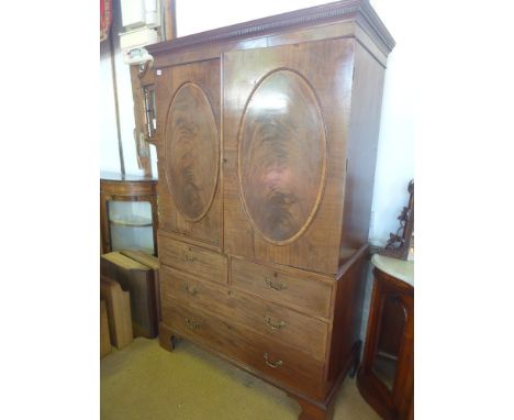 A late Georgian/William IV mahogany Linen press, dentil cornice over two oval panel doors opening to reveal two sections, one