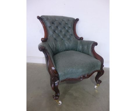 A 19th century carved mahogany button back leather armchair on shaped cabriole legs
