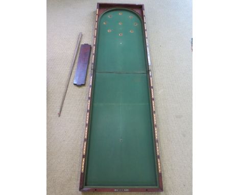 A 19th century mahogany table top Bagatelle with cue - 2.14 m open 