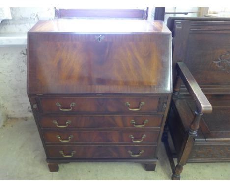A reproduction mahogany veneered fall front bureau, fall over four long drawers raised on bracket supports - 75cm x 42cm x 96