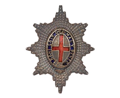 Badge. Coldstream Guards Officer Service Dress silver cap badge.  Fine small facetted silvered star mounted with pierced Gart