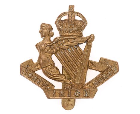 Badge. North Irish Horse brass cap badge circa 1908-52.  Good scarce die-stamped brass crowned Maid of Erin Harp, with non vo