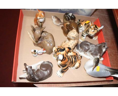 A collection of assorted continental porcelain figures to include Lomonosov model of a seated fox, a Lomonosov tiger etc