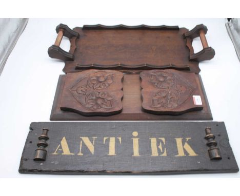 A mid-20th century oak twin handled tray together with a carved hardwood book trough, and a painted wooden Antiek sign (3)