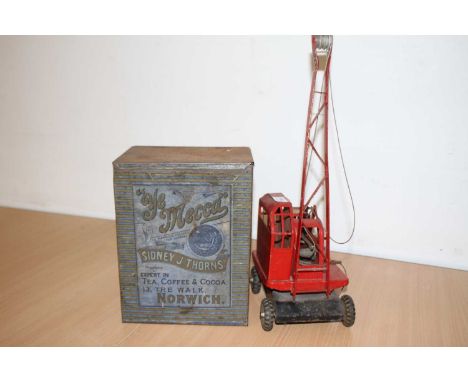 A tinplate model crane; together with a lithograph printed tin for Sidney J Thorns of Norwich tea and coffee (2)