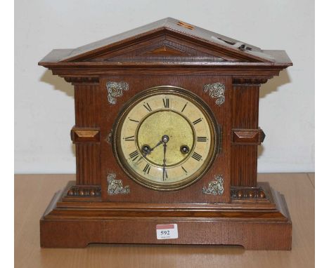 An early 20th century oak cased 8-day mantel clock, of architectural form, h.33cm