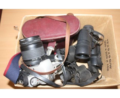 A pair of Bushnell field binoculars; one other pair; and a Canon 35mm SLR camera (3)