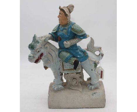 A Ming? dynasty pottery ridge tile in the form of a warrior on horseback (later painted) height 34cm