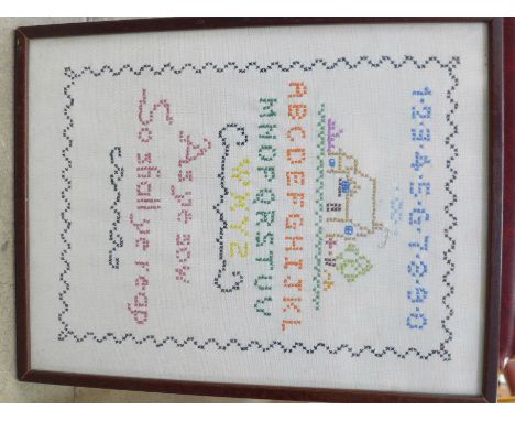 A framed needlework sampler