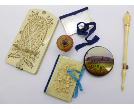 Needlework items including a Dublin Exhibition pin cushion, an ivory case and a novelty tape measure