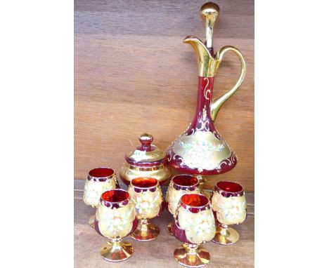 A ruby glass decanter, six glasses and a lidded jar