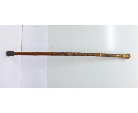 A bamboo walking stick with oriental carving