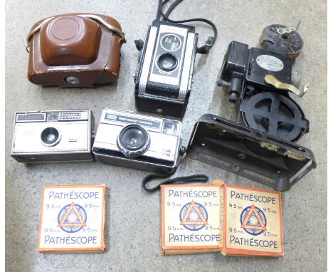 A box of cameras including Kodak Duaflex II, a Pathescope Kid film projector and three Pathescope 9.5mm film reels