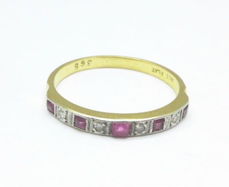 An 18ct gold, ruby and diamond nine stone ring, 2.8g, P