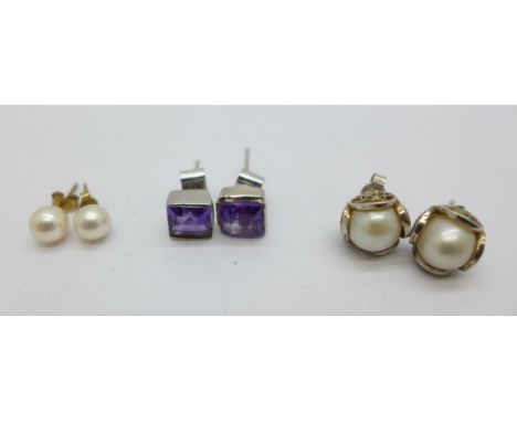 A pair of 9ct gold cultured pearl stud earrings and two pairs of silver earrings