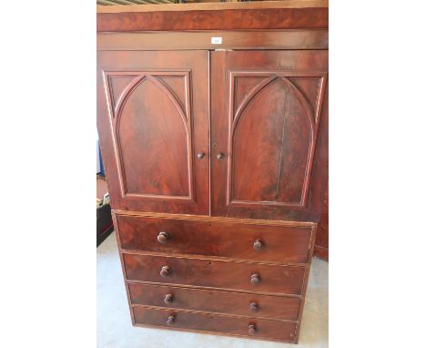 Victorian mahogany linen press, moulded cornice above two Gothic arch moulded doors and four long drawers, plinth base with b