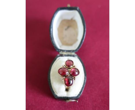 Gold ring, flowerhead set with four oval garnets, tested to high carat 