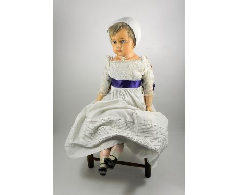 A large wax over composition shoulder head doll, German circa 1860, with fixed blue glass eyes, painted eyebrows, mouth and s