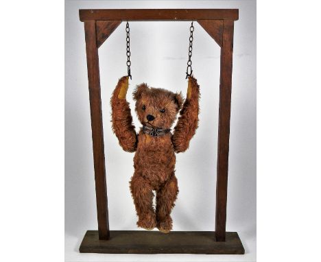 A rare Bing clockwork Somersaulting Teddy Bear, circa 1910, dark cinnamon mohair bear with black boot button eyes, stitched n