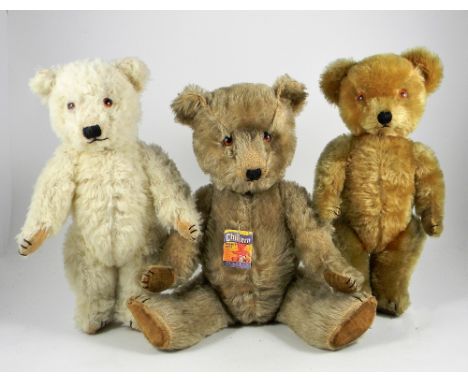 Three Chiltern Teddy Bears, post-war, white wool Hugmee bear, with glass eyes, stitched nose, mouth and claws, velveteen pads