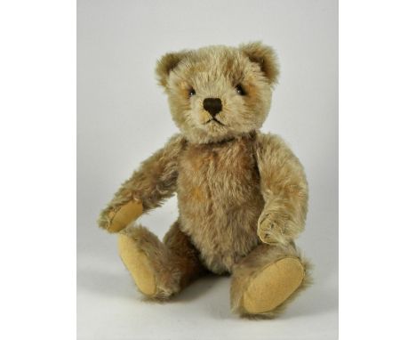 A Steiff light brown mohair Original Teddy, 1950s, straw stuffed bear with brown glass eyes, vertically stitched nose and mou