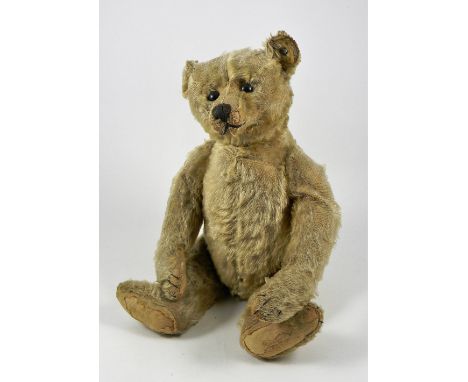 A rare centre seam Steiff blonde mohair Teddy Bear, circa 1909, straw stuffed with black button eyes, black stitched nose, mo