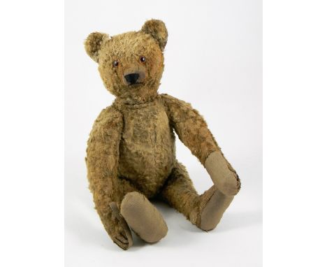 A Steiff brown cotton plush Teddy Bear, circa 1949, straw stuffed with orange glass eyes, black stitched nose, mouth and claw