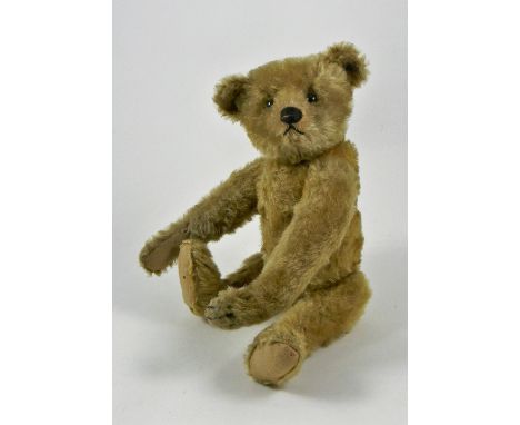 A charming Steiff light brown mohair Teddy Bear, circa 1909, straw stuffed with black button eyes, black stitched nose, mouth