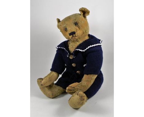 A large Steiff light brown mohair Teddy Bear, circa 1909, straw stuffed with black button eyes, black stitched nose, mouth an