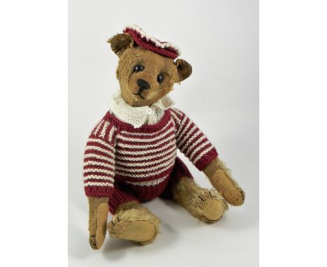 A Steiff blonde mohair Teddy Bear, circa 1909, straw stuffed with black button eyes, black stitched nose, mouth and claws, sw