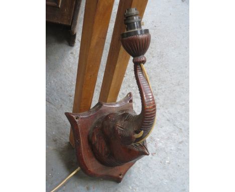 CARVED ELEPHANT FORM WALL MOUNTING LAMP.
