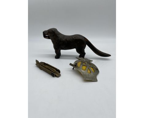 Dog Shaped Nut Cracker, AA Badge, and Model of Golden Arrow. 