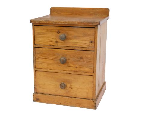 A Victorian stripped pine chest, the top with a raised back, with a rounded edge above three drawers, on a plinth base, 83cm 
