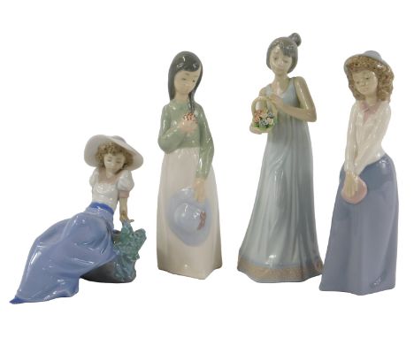 Four Nao porcelain figures, modelled as a lady holding a flower basket, 26cm high, a lady seated, and two others. (3 boxed)
