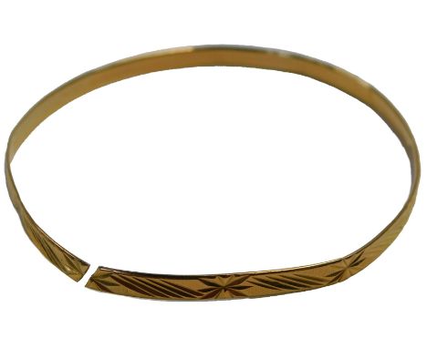 A bangle with engraved decoration, cut, unmarked, tests as 22ct, 7.8g. (AF)