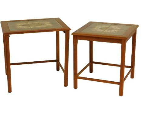A 1970s nest of two teak tables, each with a tile top, on square chamfered legs united by stretchers, the largest 46cm high, 