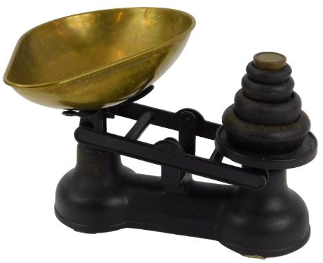 A pair of cast iron Salter kitchen scales, a brass weighing bowl, and various cast iron and brass weights.