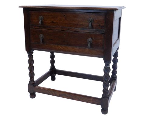 An early 20thC oak canteen table, the rectangular top with moulded edge above two fitted drawers, on barley twist supports un