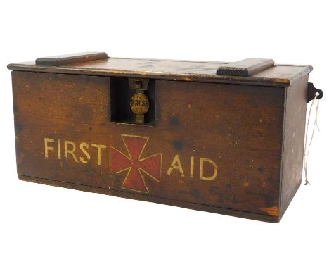 An early 20thC pine first aid box, with a pressed button catch, opening to reveal a fitted interior, with some contents, the 