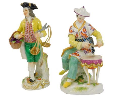 A 20thC Meissen porcelain figure, modelled as a Gentleman wearing an Oriental dress beside a drum, blue crossed and impressed