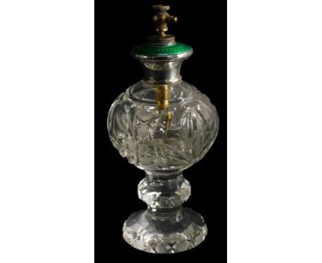 An early 20thC cut glass atomiser, with a silver mount, inset with green guilloche enamel, stamped sterling silver, 17cm high