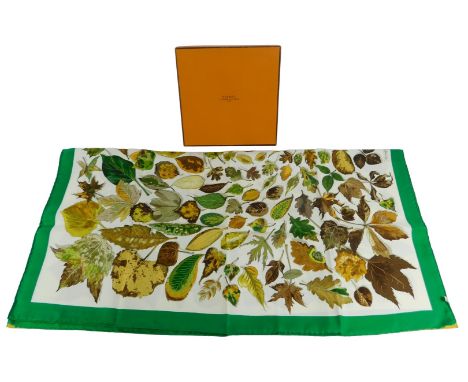 A Hermes silk scarf, decorated with autumnal leaves within a green border, 87cm x 87cm, boxed.