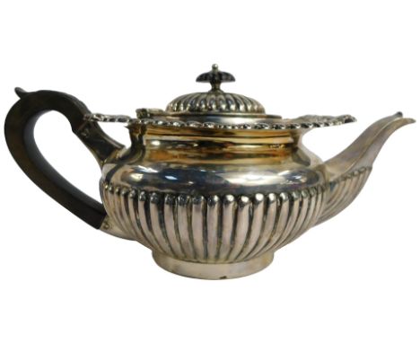 An Edward VII silver teapot, of semi fluted form, with ebonised knop and handle, J&amp;J Maxfield Ltd, Sheffield 1904, 23.73o