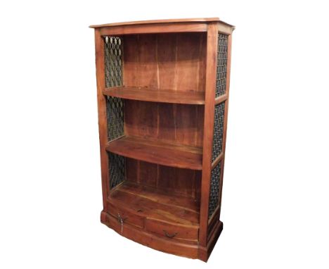 An Eastern hardwood bow front bookcase, with three shelves and pierced metal sides, two drawers to the base, on a plinth, 150