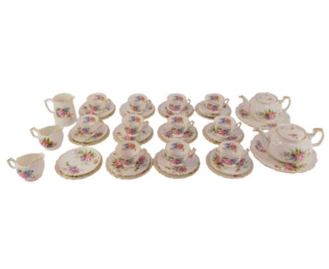 An Aynsley porcelain tea service, decorated with flowers against a white ground, gilt heightened, comprising two graduated te