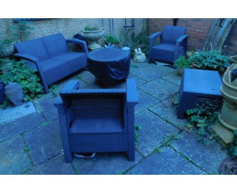 A Keter woven garden suite, comprising two seater sofa, two armchairs, table and a cushion cover box, together with eight cus