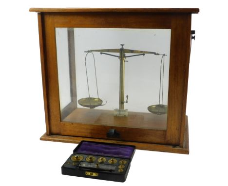 A set of Beckers Sons Rotterdam brass chemist's scales, in an oak case, 39cm high, 44cm wide, 27.5cm deep, together with a ca
